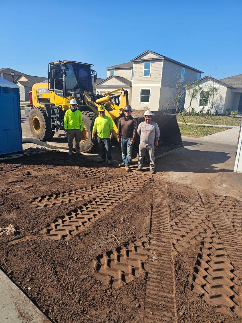 CCE crew and wheel loader on a freshly graded homesite